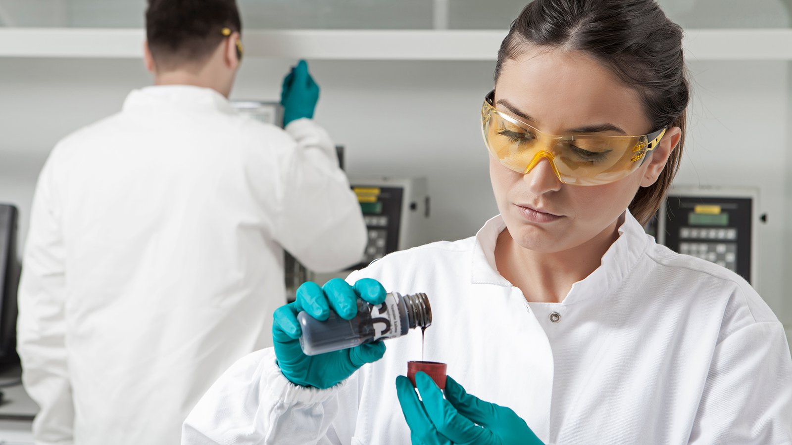 SGS laboratory technician performing industrial quality control analysis in a modern testing laboratory environment.