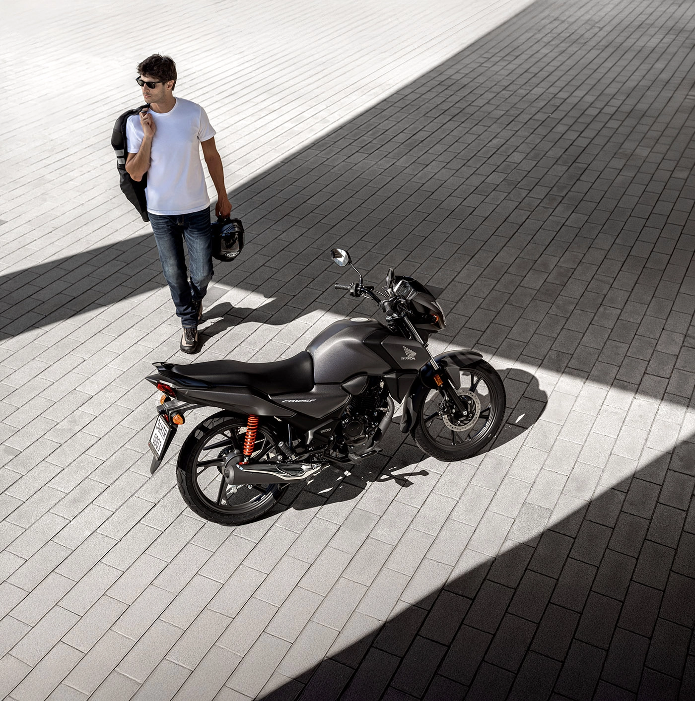 Honda motorcycle with rider in modern urban lifestyle setting