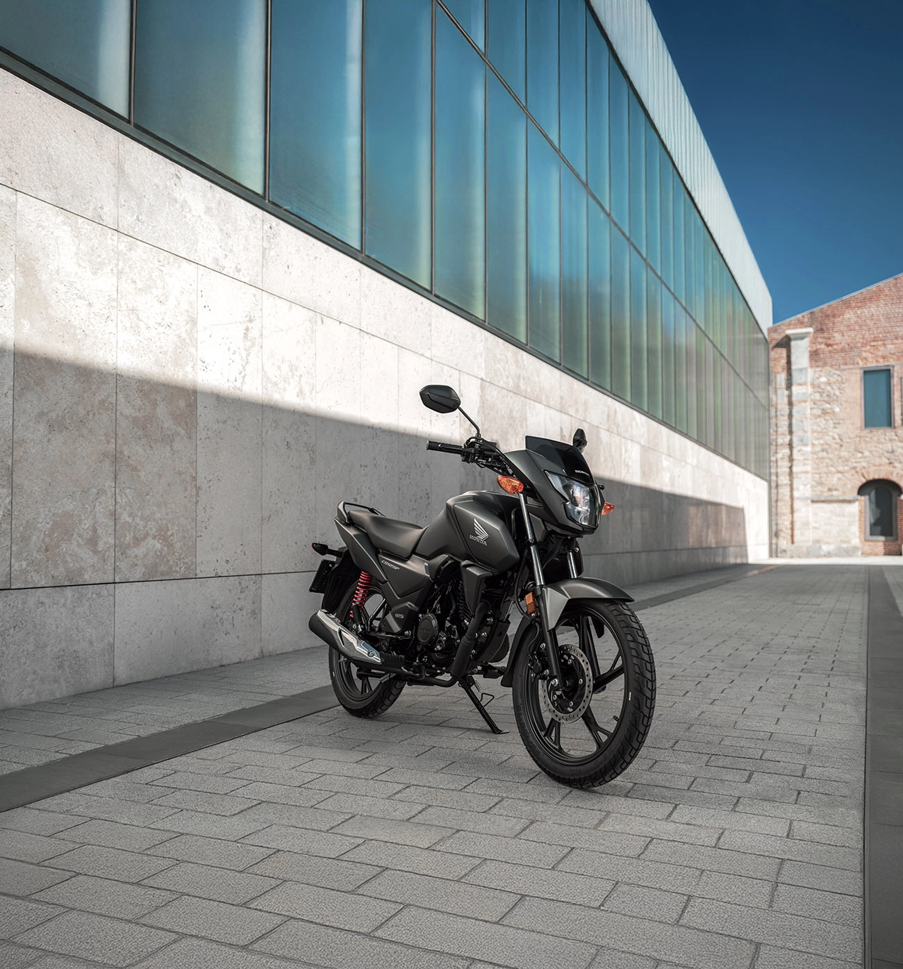 Honda motorcycle parked in modern urban architecture setting
