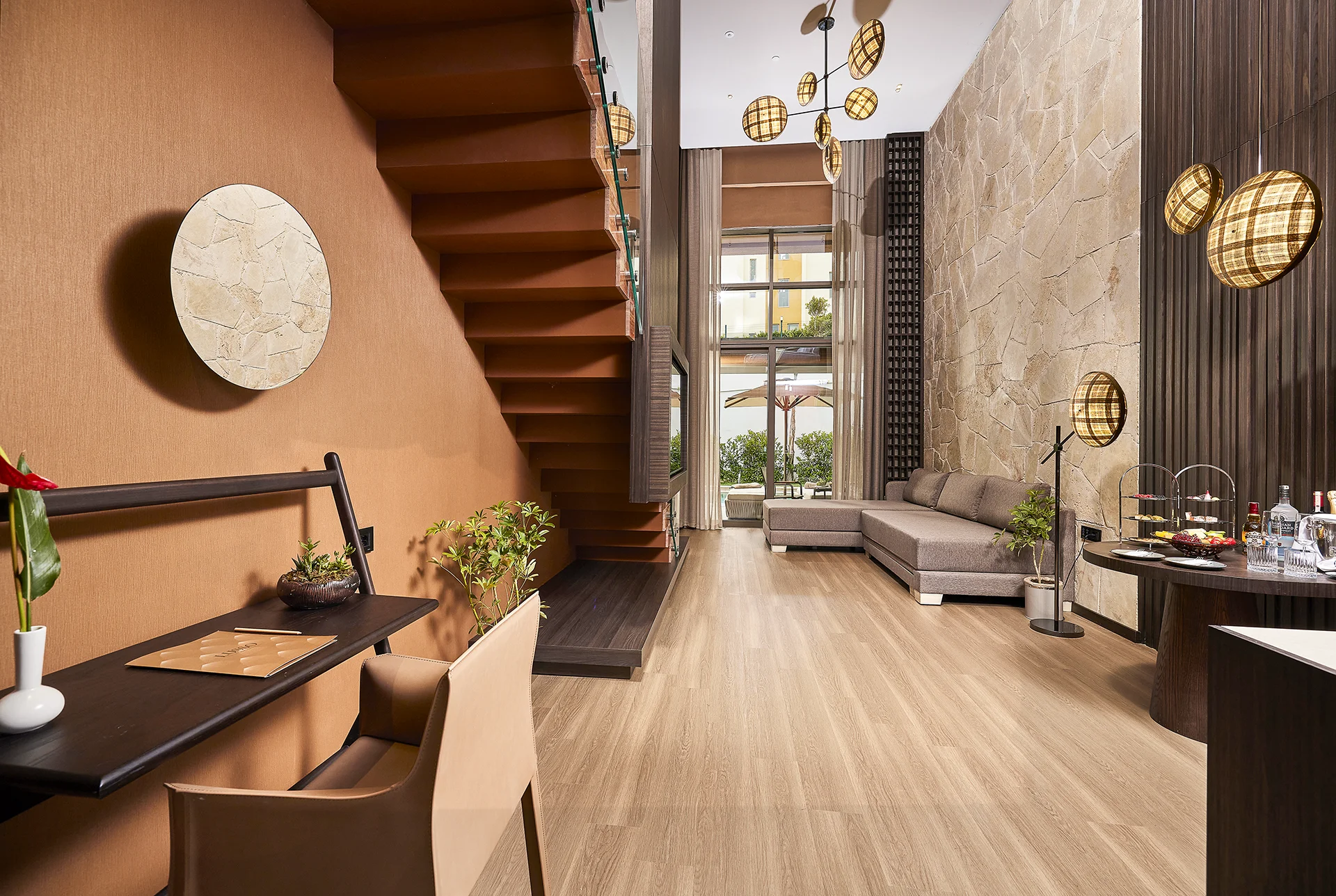 Luxury interior at Lusso Resort featuring contemporary architecture, warm wood finishes, designer lighting, and elegant living spaces