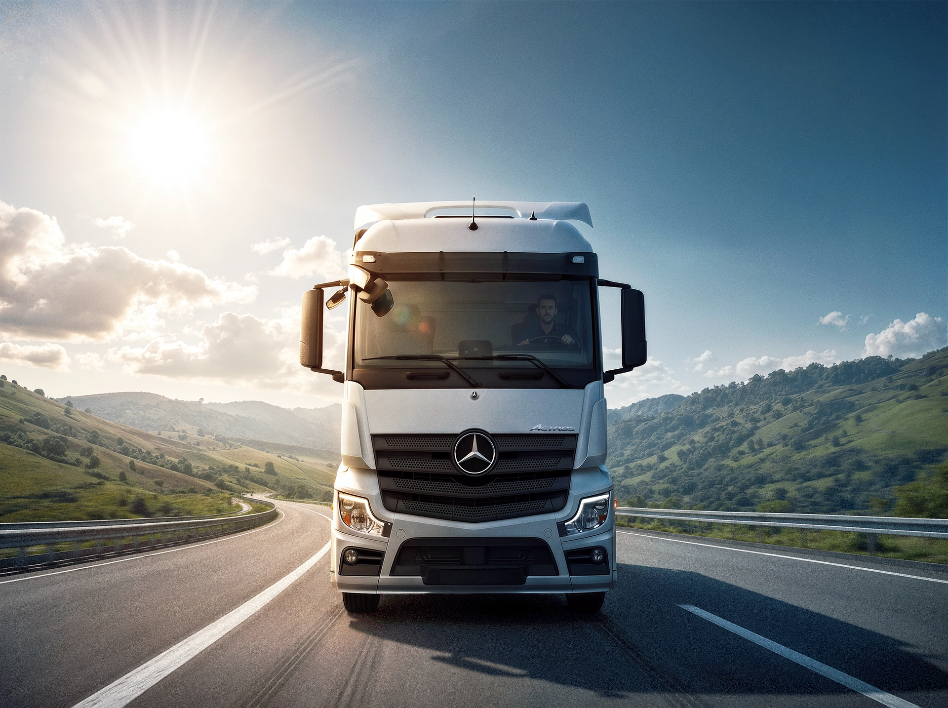 Mercedes-Benz Actros truck driving on highway through mountain landscape