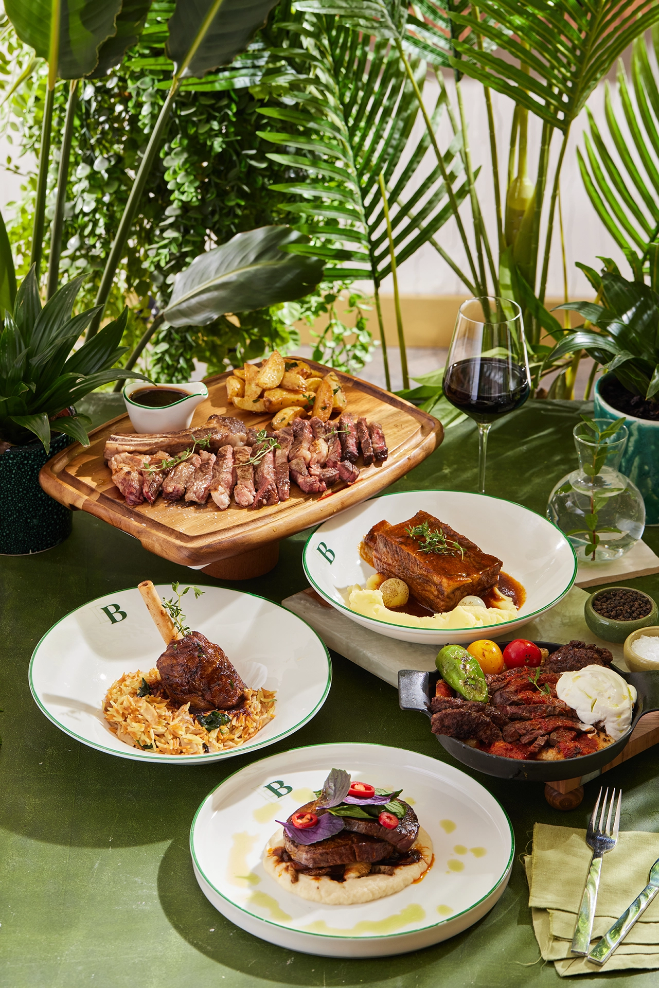 Gourmet dining table featuring a selection of premium dishes, fresh ingredients, and elegant food presentation in a tropical setting.