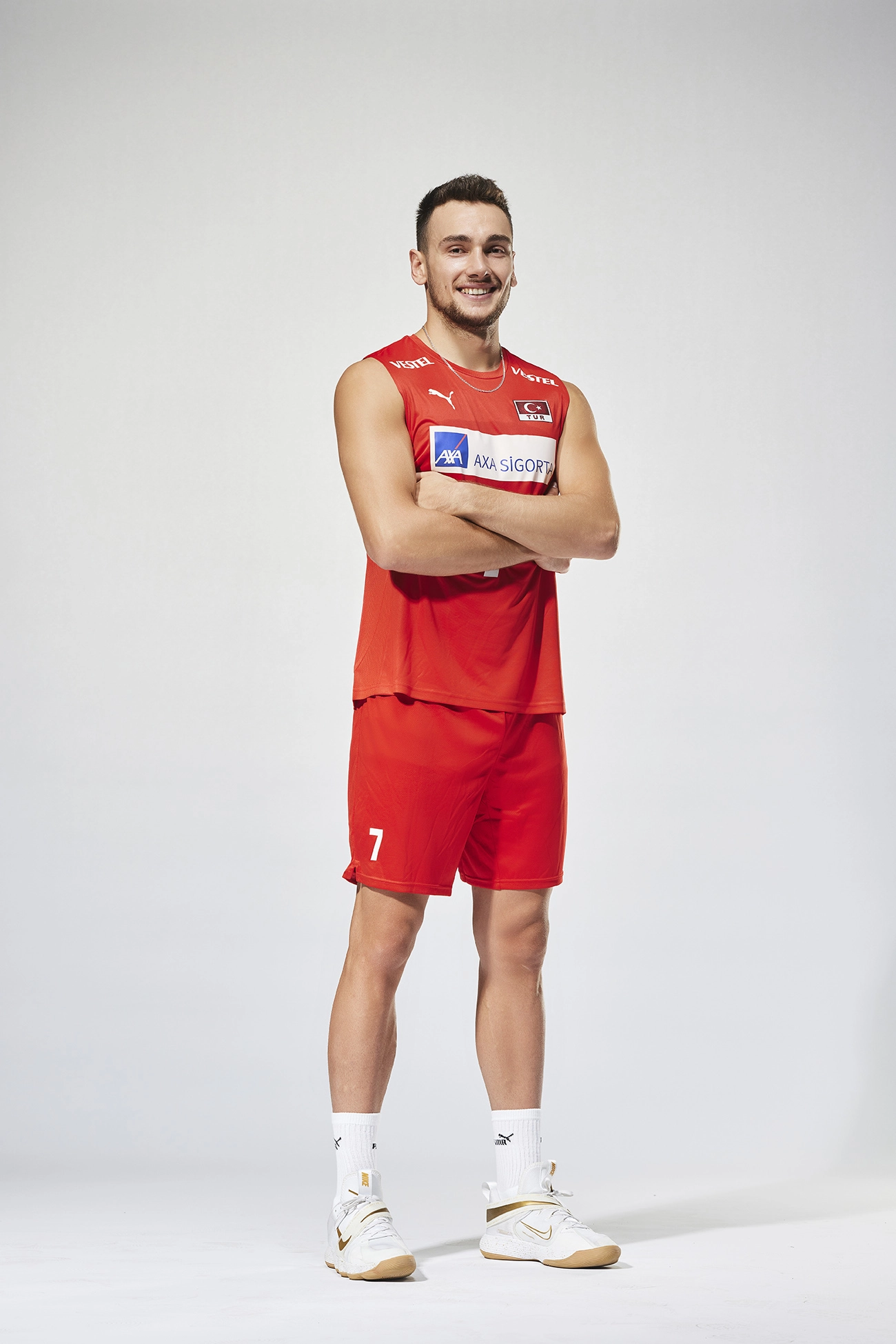 Professional portrait of Turkish national volleyball player Bedirhan Bülbül in the official Türkiye Men’s National Volleyball Team uniform, photographed for a Puma sportswear campaign on a white studio background.