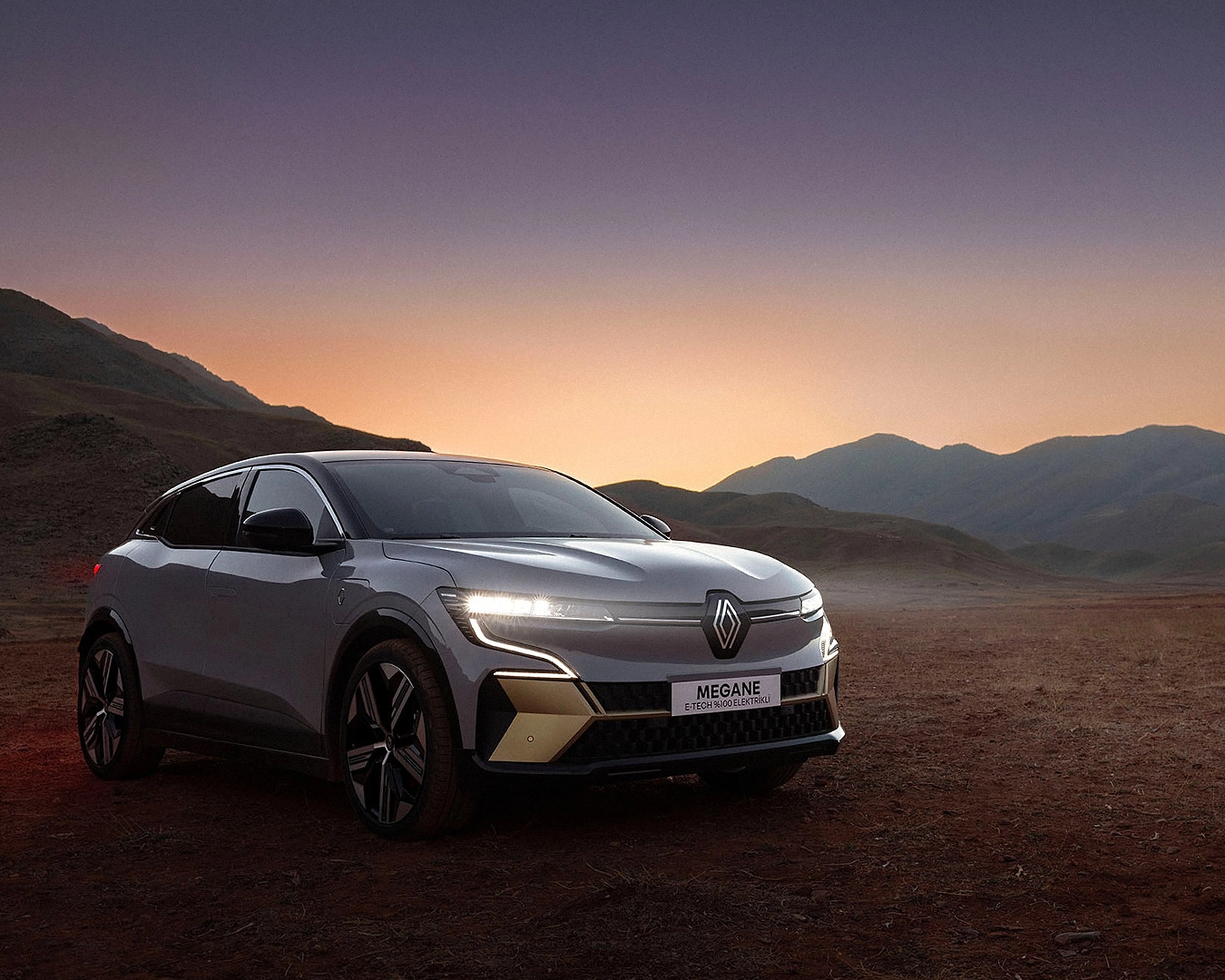 Renault Megane E-Tech electric vehicle in mountain landscape at sunset