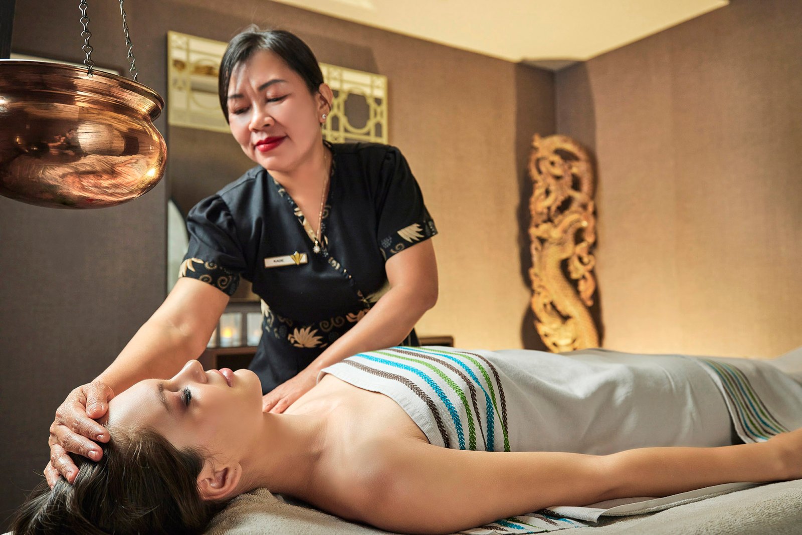 Professional spa therapist providing a relaxing wellness treatment at Rixos Sungate Hotel spa in Antalya, showcasing luxury hospitality, wellness services, and resort spa experiences.