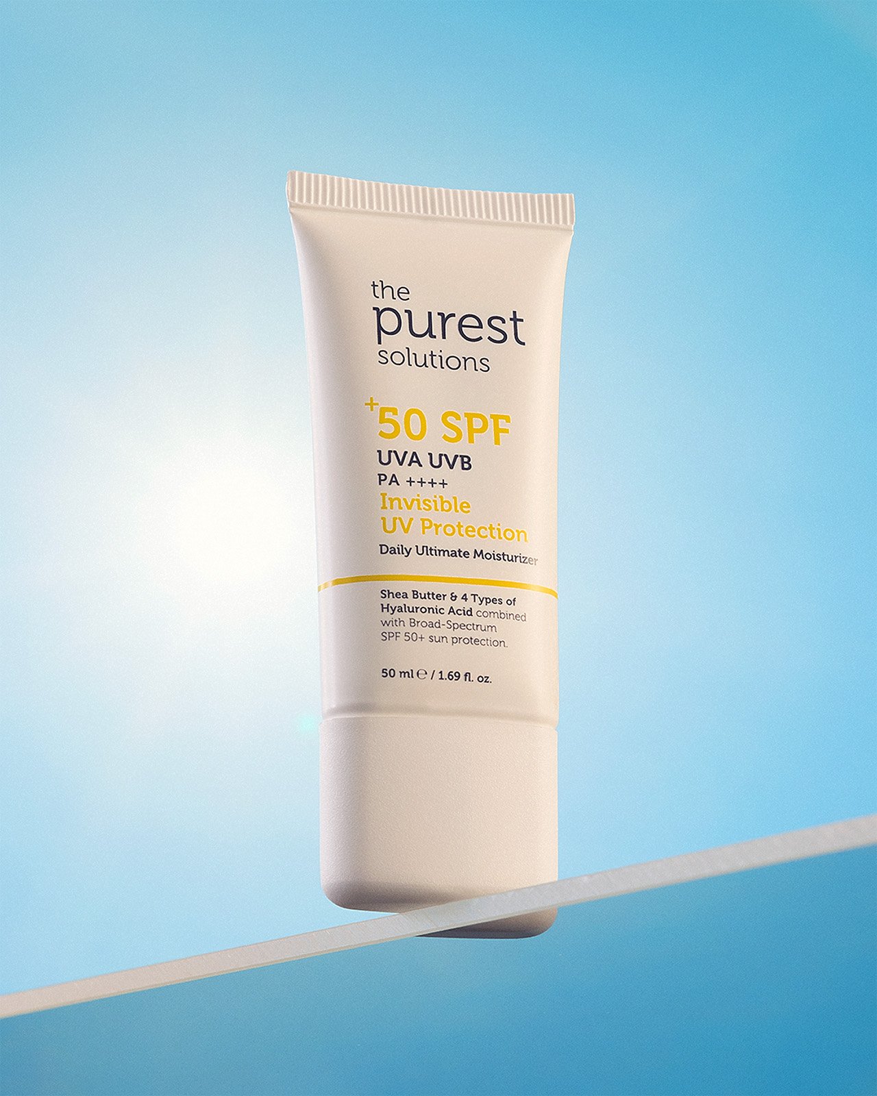 Purest sunscreen cream tube on blue background with minimalist product styling