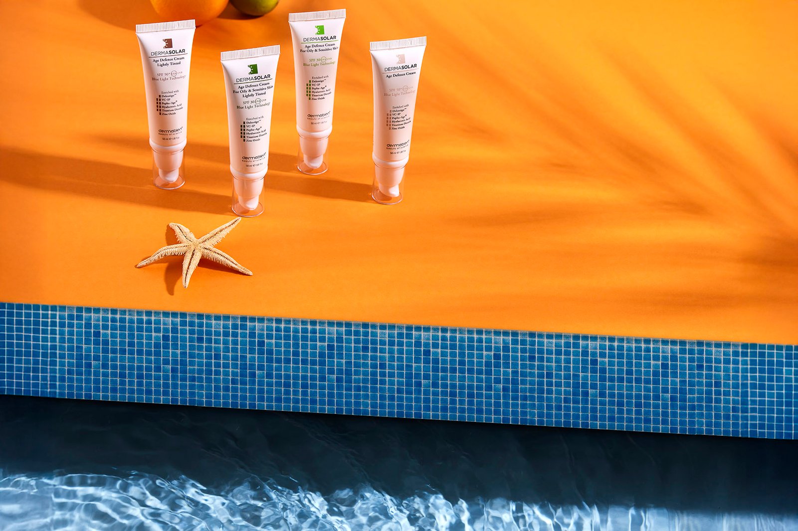 Dermabien skincare products displayed on a beach towel with summer lifestyle styling
