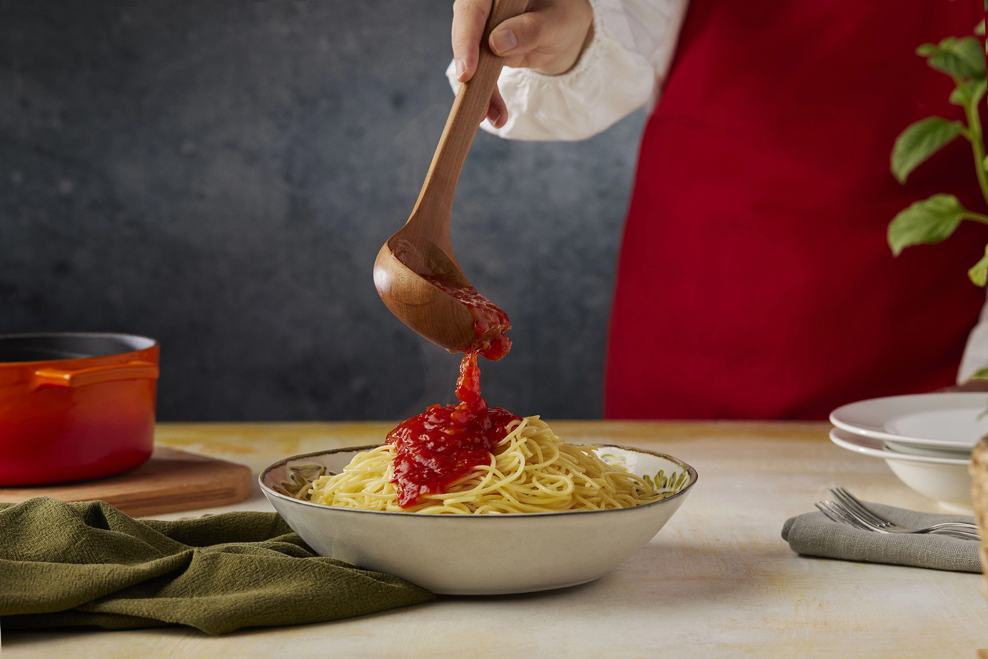 Arbella spaghetti served with rich tomato sauce and fresh ingredients in an elegant food styling composition.