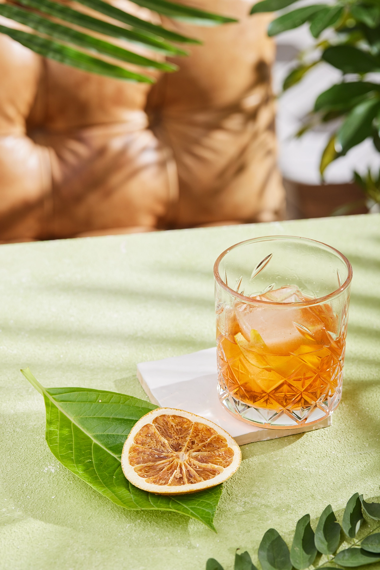 Refreshing citrus cocktail served with fresh lime slices and ice in a tropical-inspired setting.