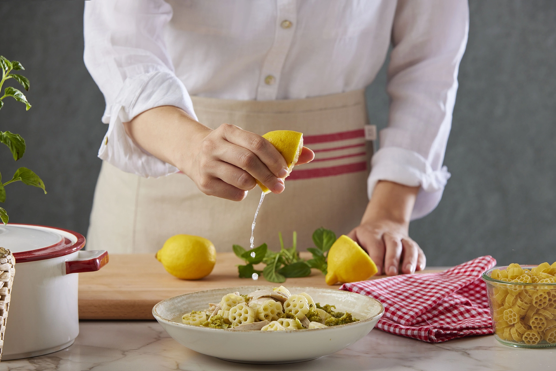 Arbella tagliatelle pasta prepared with fresh salmon and premium ingredients during the cooking process.