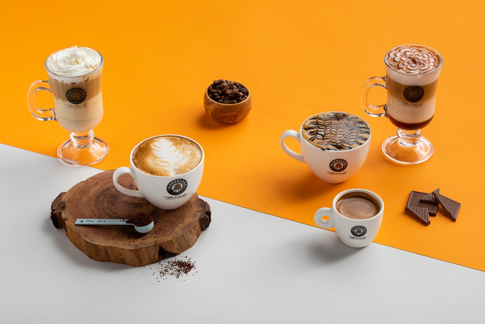 Professional commercial beverage advertising photographs by Sinan Niyazi Kutsal capturing freshly poured artisan coffee cups surrounded by roasted beans, and specialty cold brew coffee bottles on a sleek modern cafe table.