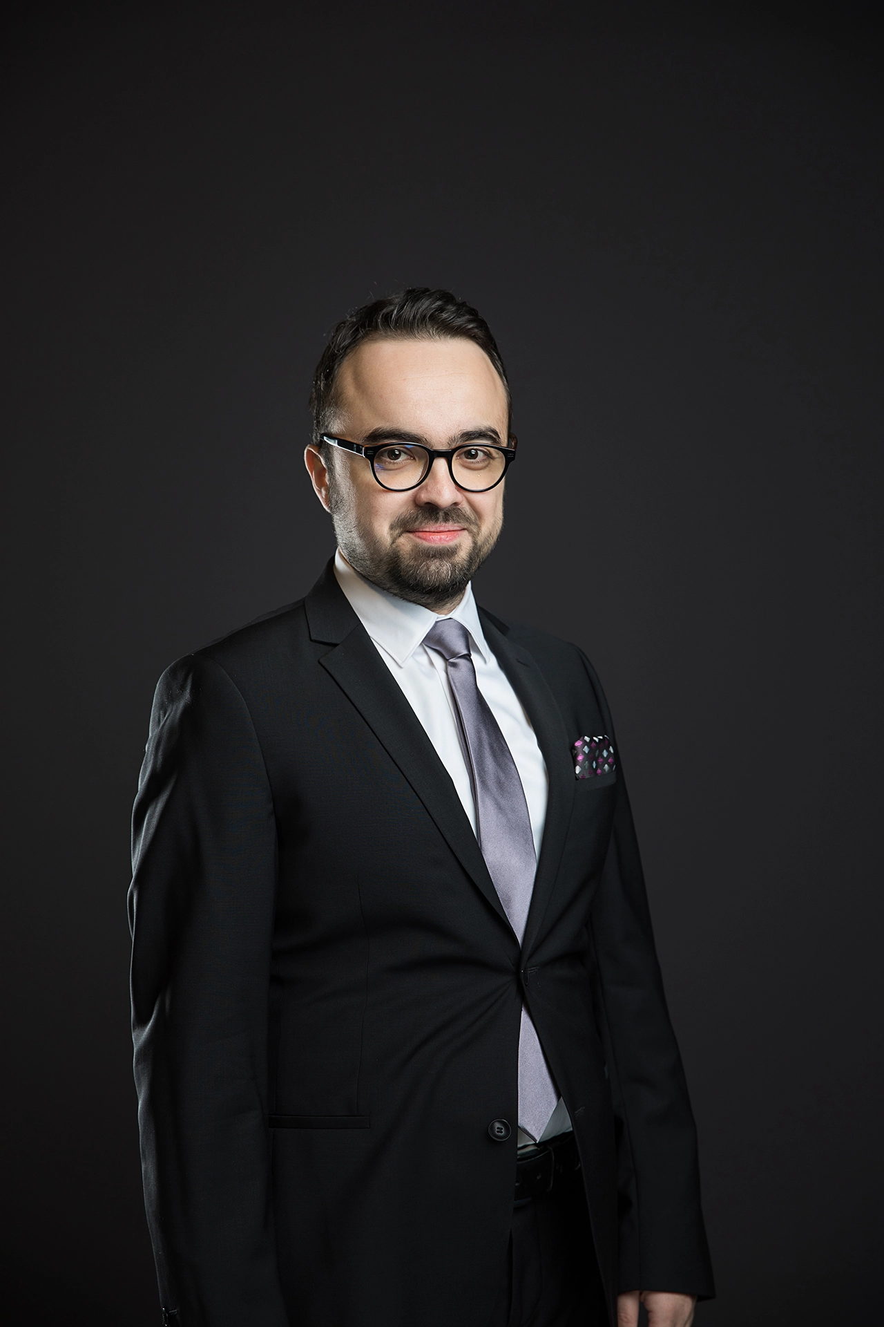 Professional corporate portrait of a businessman in a suit photographed in a studio environment for executive branding, LinkedIn profile and business communications.