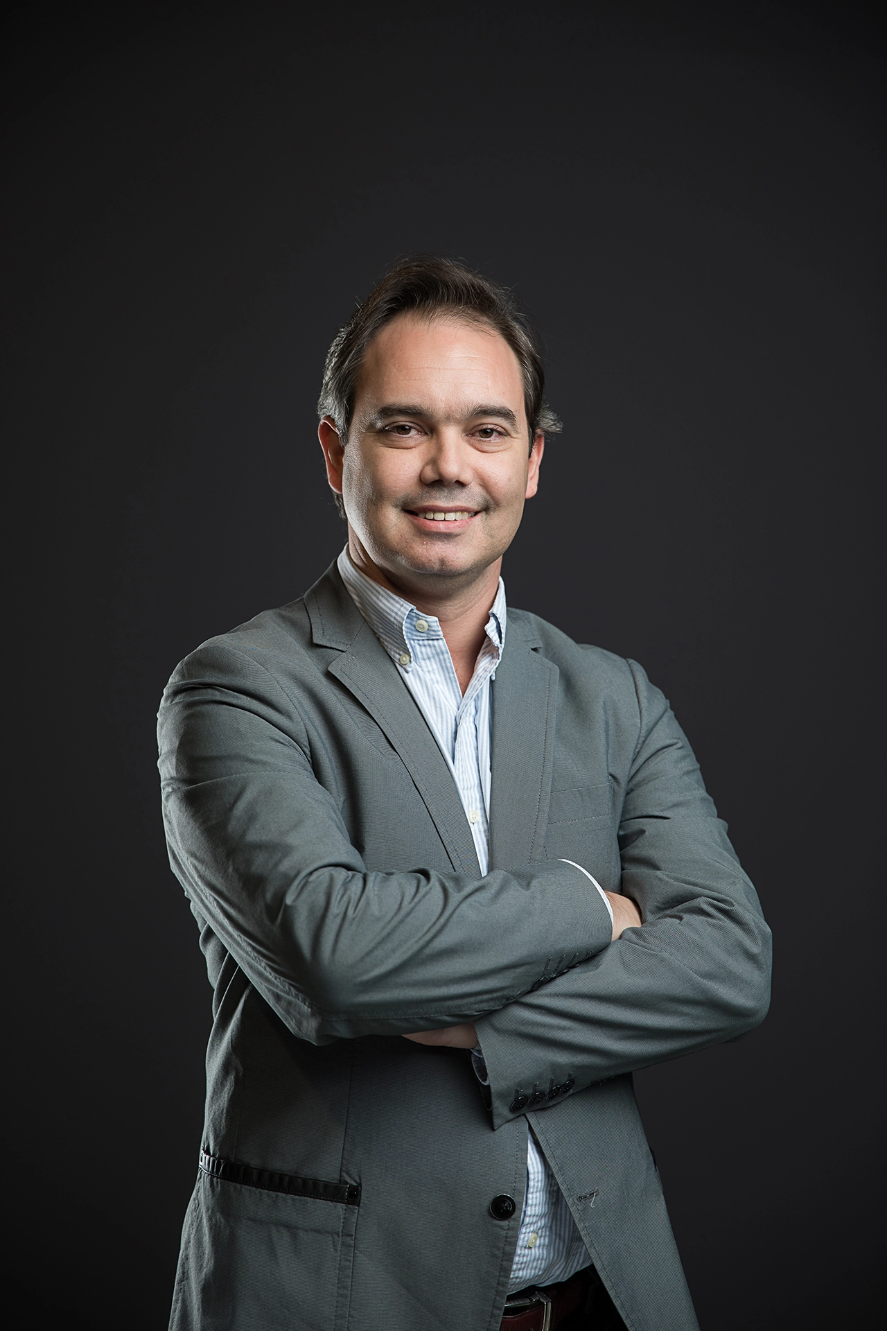 Professional executive portrait of a business leader with crossed arms, photographed for LinkedIn profile and corporate branding.