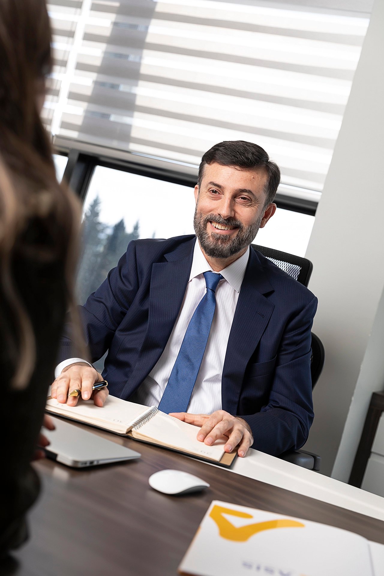 Professional executive portrait photographed in a corporate office environment.