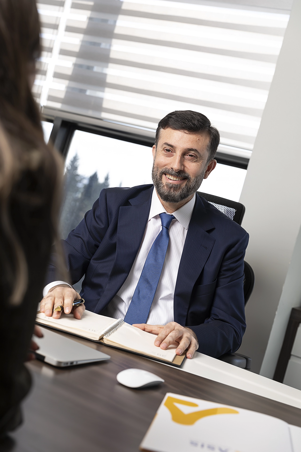 Executive portrait of a CEO seated at his office desk, photographed for corporate branding, leadership communications and LinkedIn profile.