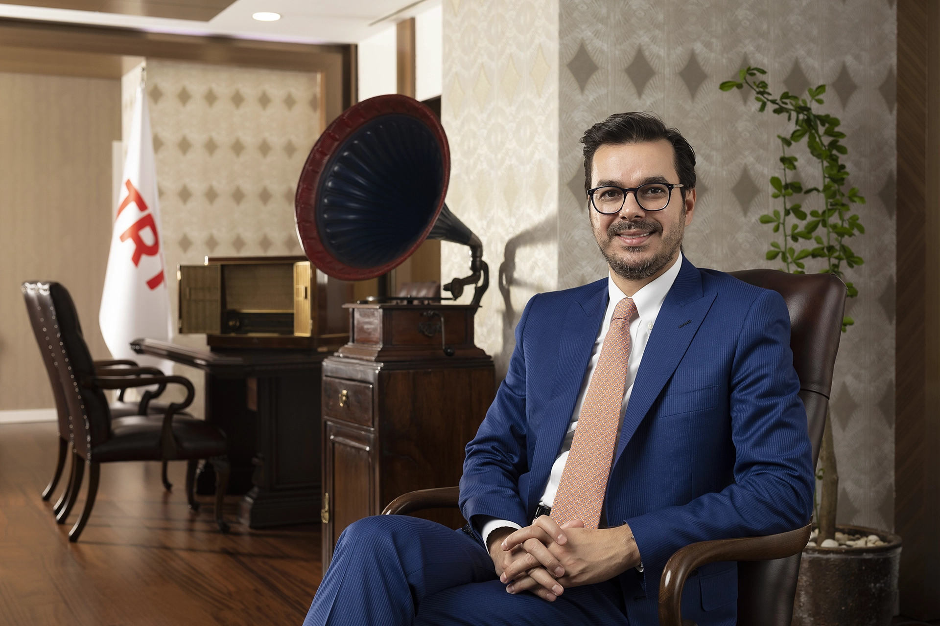 Executive portrait of a media industry leader photographed in an office environment for corporate communications and executive branding.