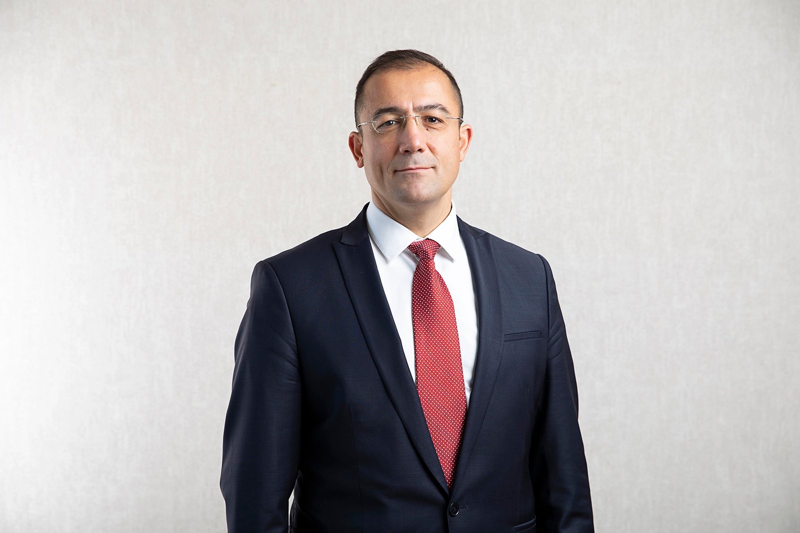 Professional executive portrait photographed in a corporate office environment.