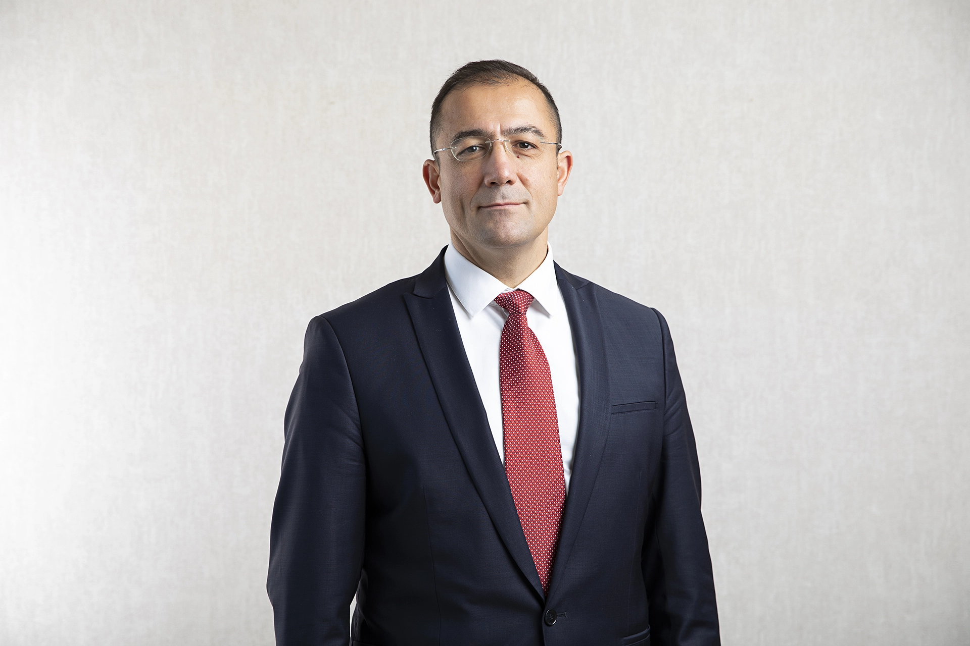 Professional executive headshot of a business leader in a suit, photographed for LinkedIn profiles and corporate branding.