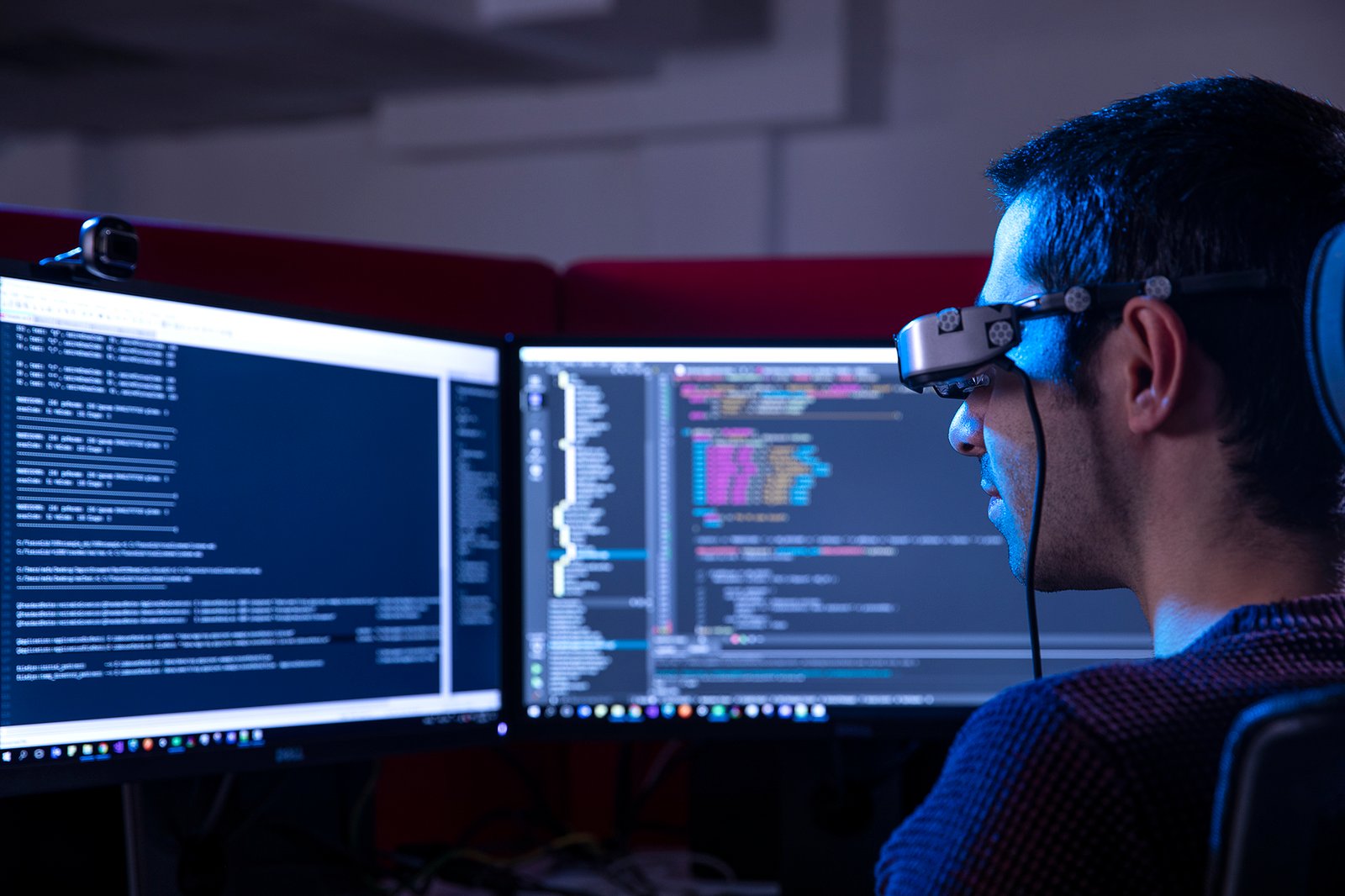 Professional commercial corporate photographs by Sinan Niyazi Kutsal for Havelsan, capturing tech engineers and corporate professionals monitoring advanced digital screens, coding, and testing simulation units inside modern software development laboratories.