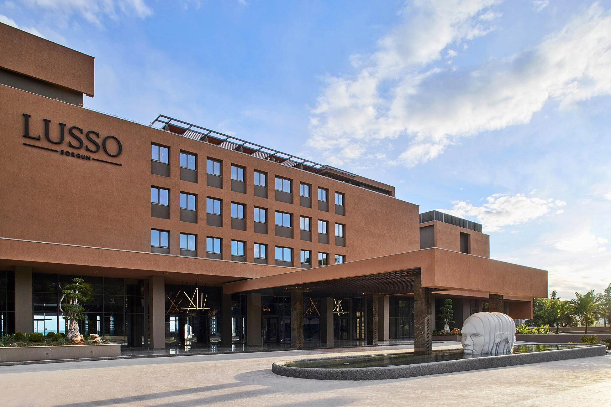 Exterior view of Lusso Hotel showcasing modern architecture, hospitality design and luxury accommodation facilities.