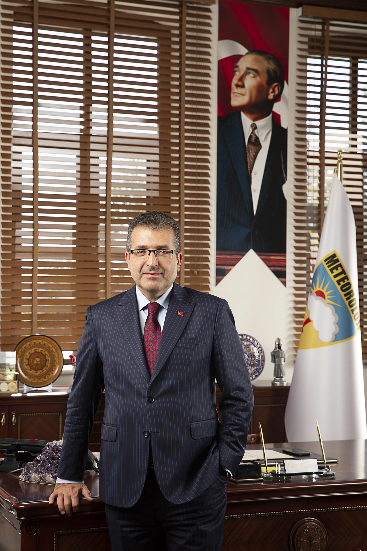 Official executive portrait of a public institution leader photographed in a government office environment for corporate communications and leadership branding.