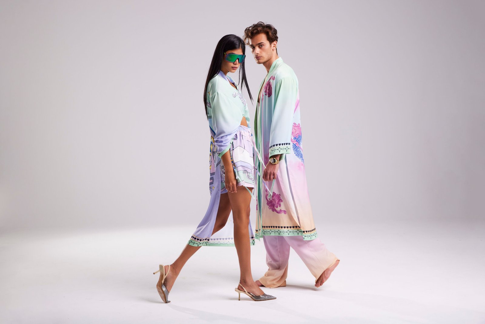 Professional commercial fashion studio photographs by Sinan Niyazi Kutsal for Je te veux, capturing young models in silk scarf crop tops, gradient kimonos, and premium embroidered shirts posing against a crisp white background.