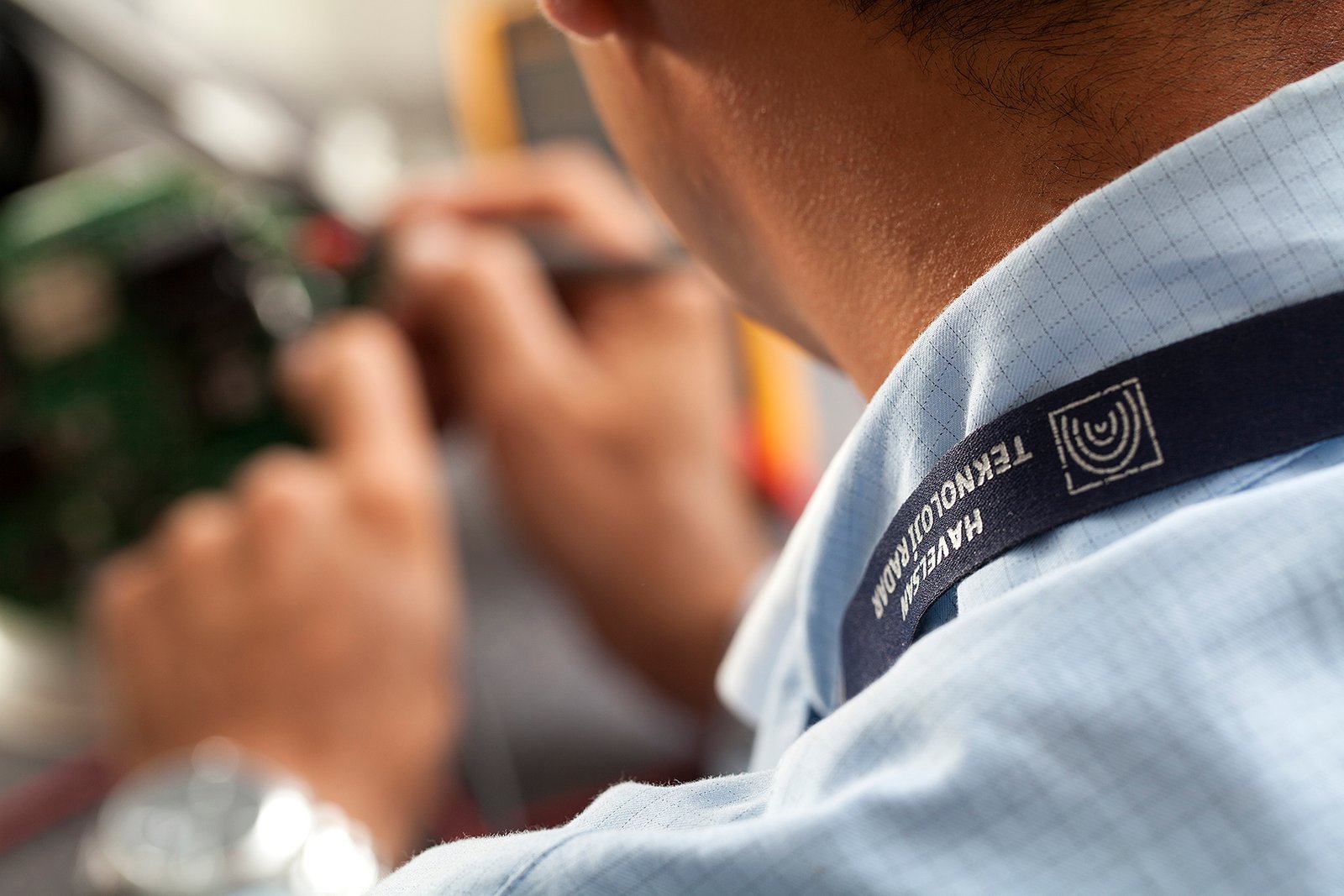 Professional commercial corporate photographs by Sinan Niyazi Kutsal for Havelsan, capturing tech engineers and corporate professionals monitoring advanced digital screens, coding, and testing simulation units inside modern software development laboratories.