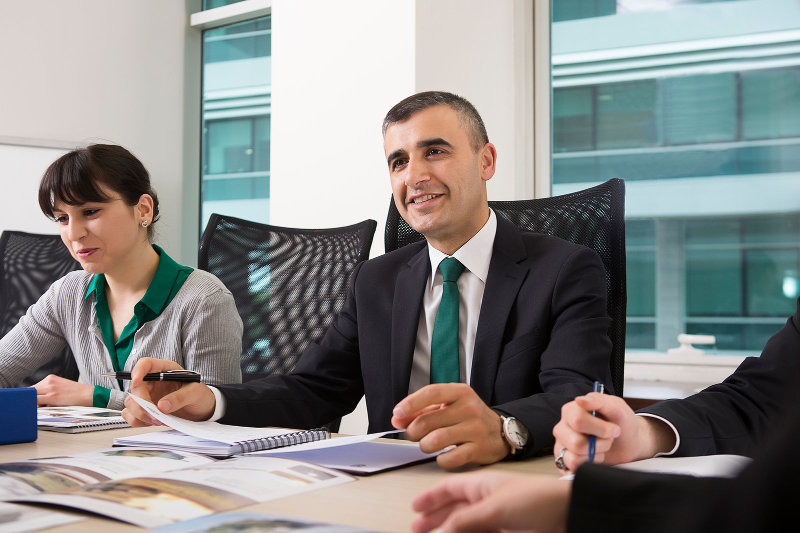 Professional executive portrait photographed in a corporate office environment.