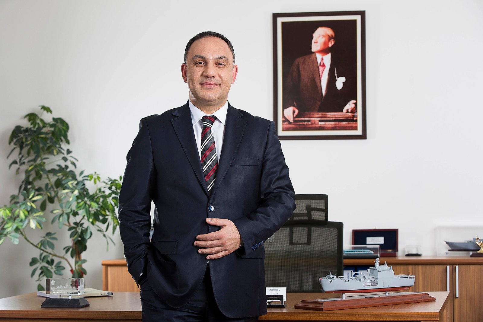 Professional executive portrait photographed in a corporate office environment.