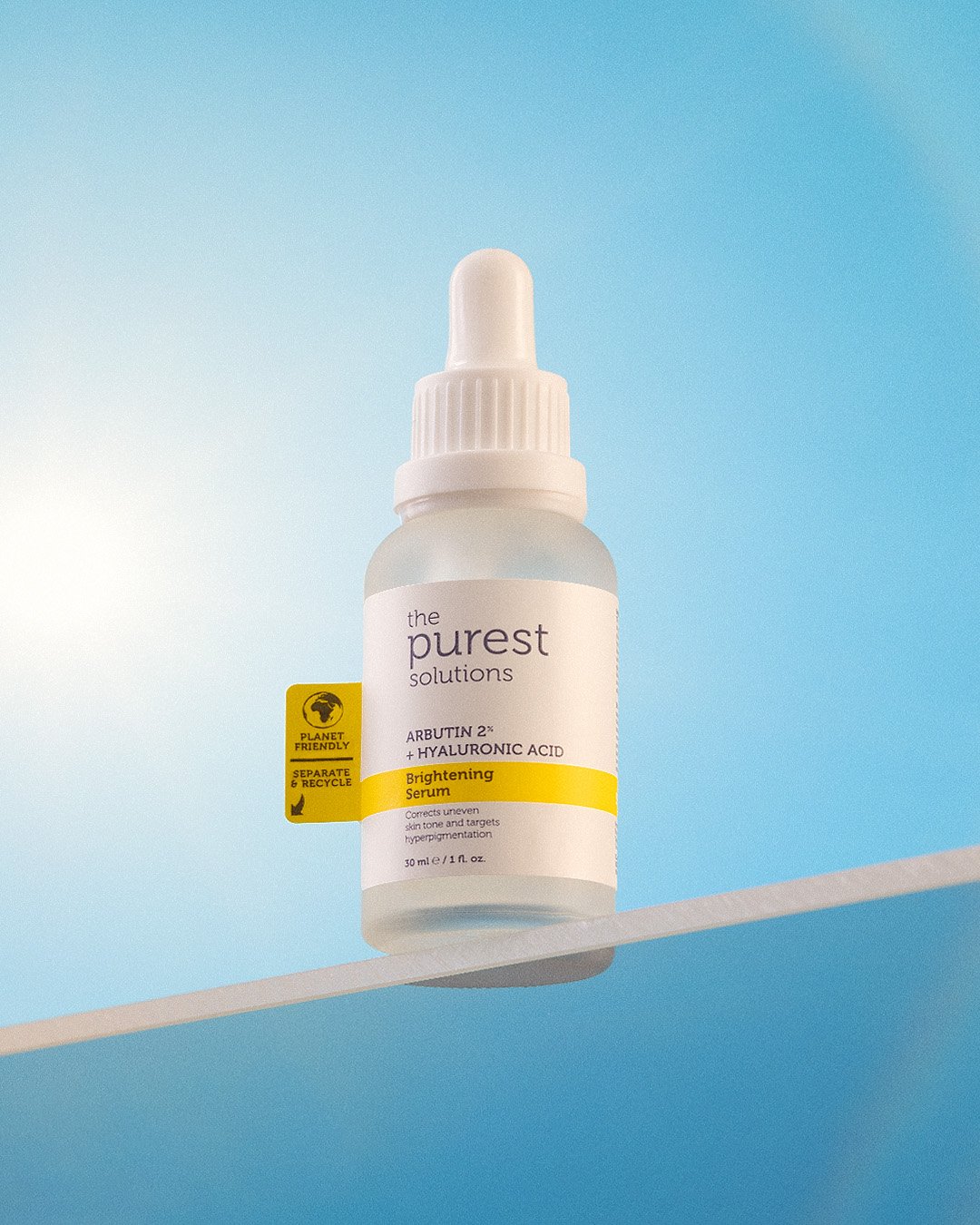 Professional commercial product advertising photographs by Sinan Niyazi Kutsal for The Purest Solutions, showcasing premium skincare serums, toners, and sunscreen tubes arranged elegantly on white geometric props with water drops.