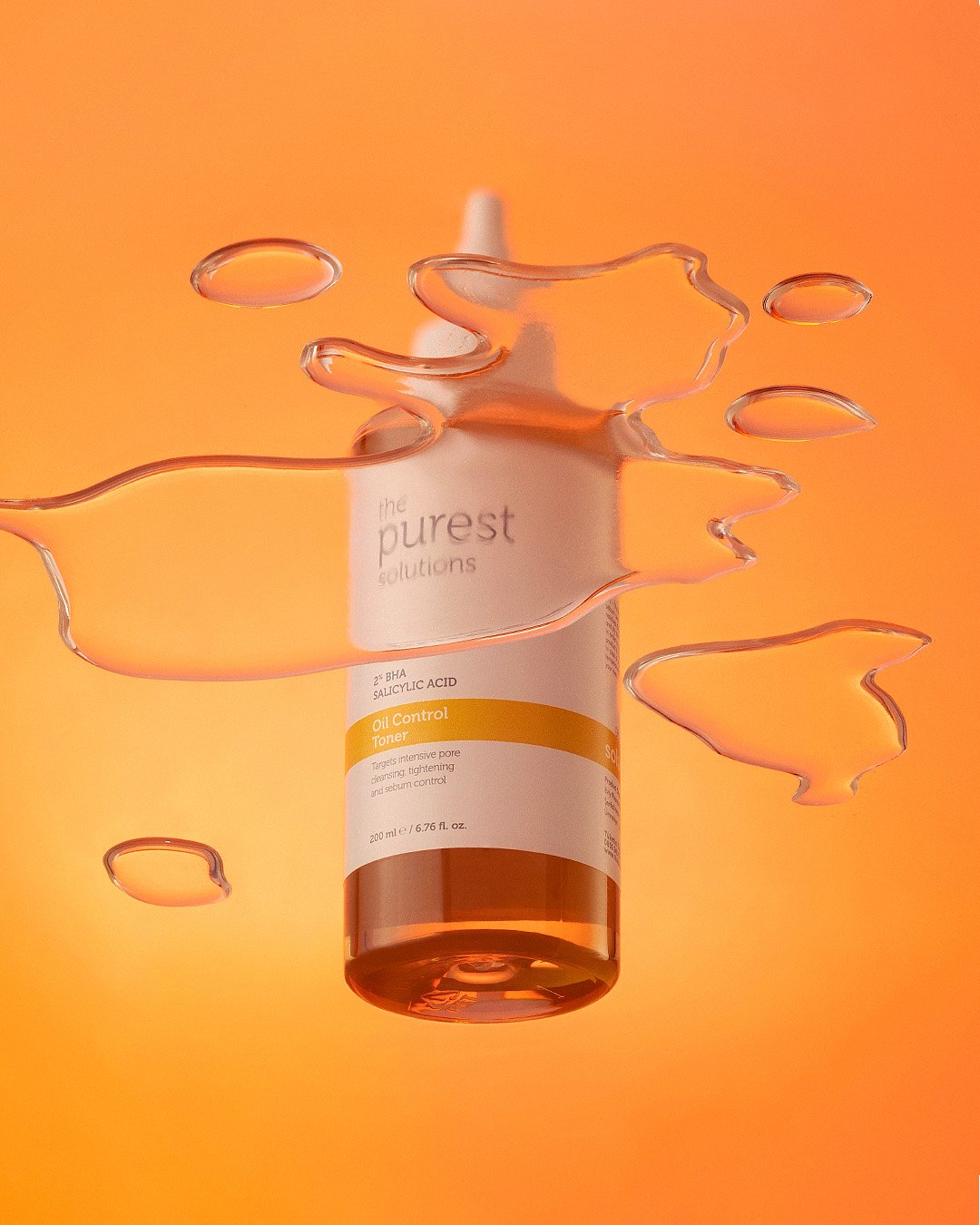 Professional commercial product advertising photographs by Sinan Niyazi Kutsal for The Purest Solutions, showcasing premium skincare serums, toners, and sunscreen tubes arranged elegantly on white geometric props with water drops.