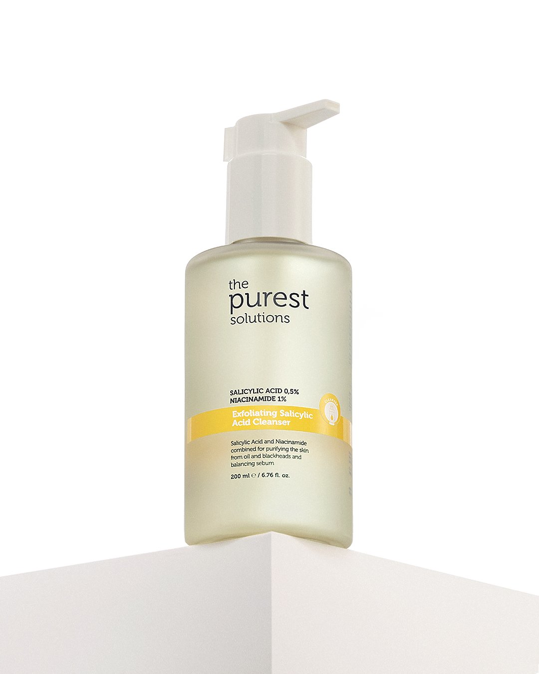 Professional commercial product advertising photographs by Sinan Niyazi Kutsal for The Purest Solutions, showcasing premium skincare serums, toners, and sunscreen tubes arranged elegantly on white geometric props with water drops.