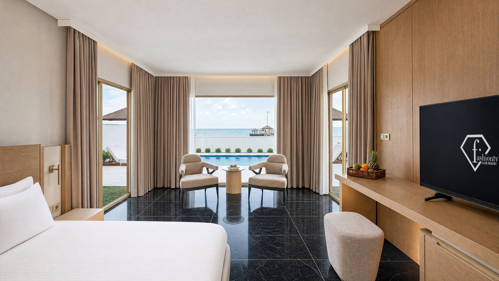 Luxury hotel bedroom with sea view, floor-to-ceiling windows, contemporary furnishings and a bright hospitality atmosphere.